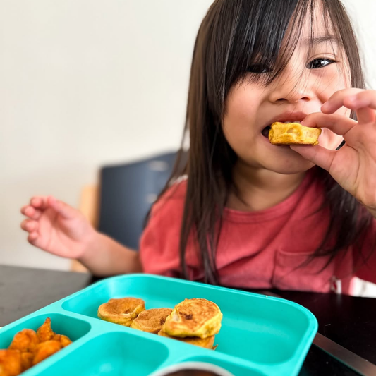 a child enjoying her pumpkin banana pancake bites