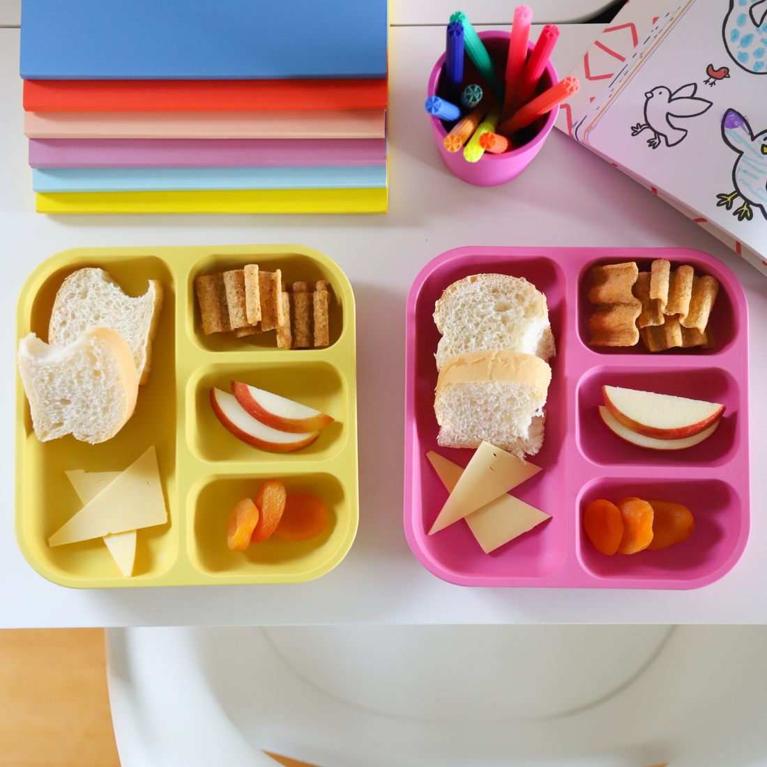 plant-based divided plates with snacks in the compartments