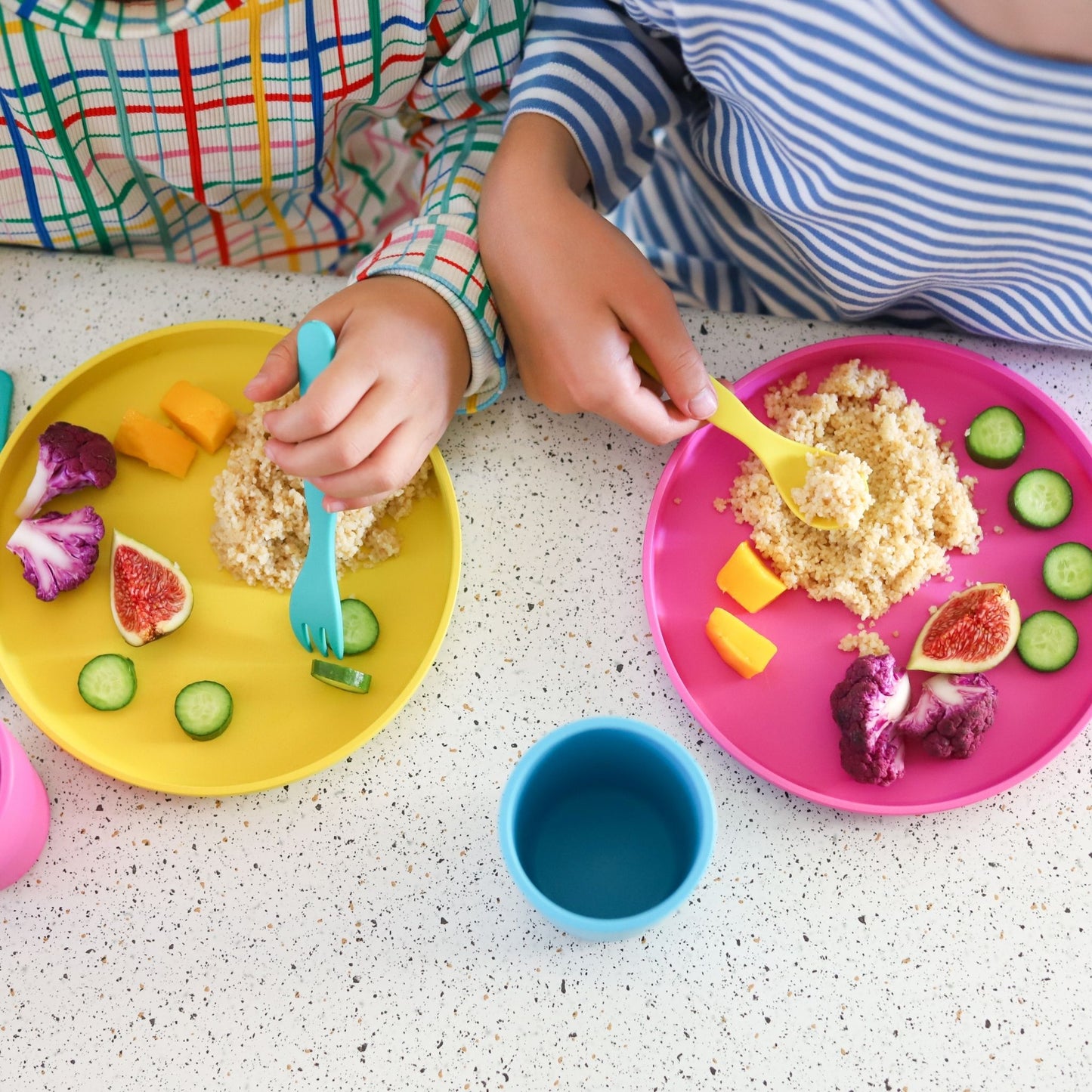 kids using bobo&boo cutlery with their eco-friendly plates that have food on them