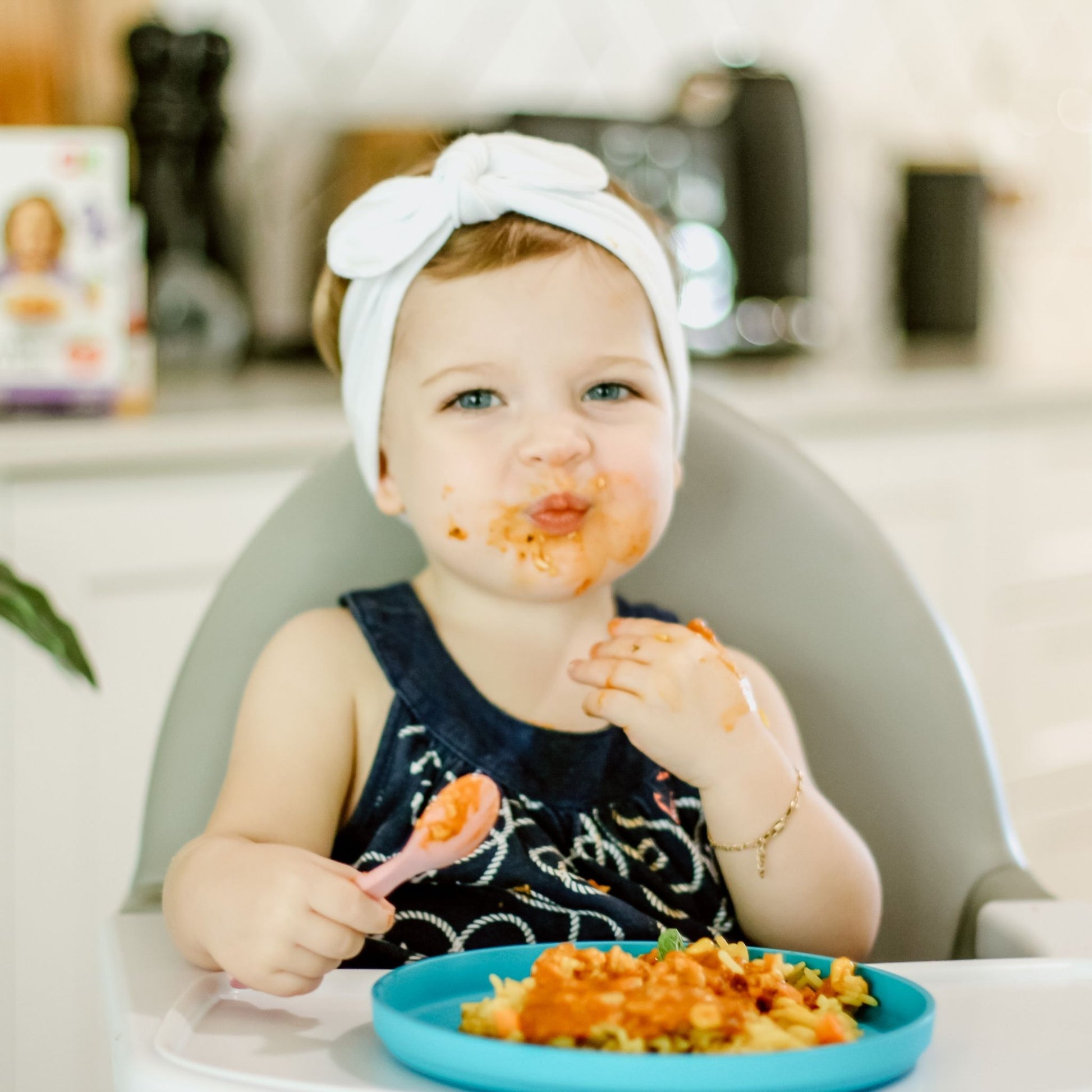 girl eating curry with a bamboo spoon & plate